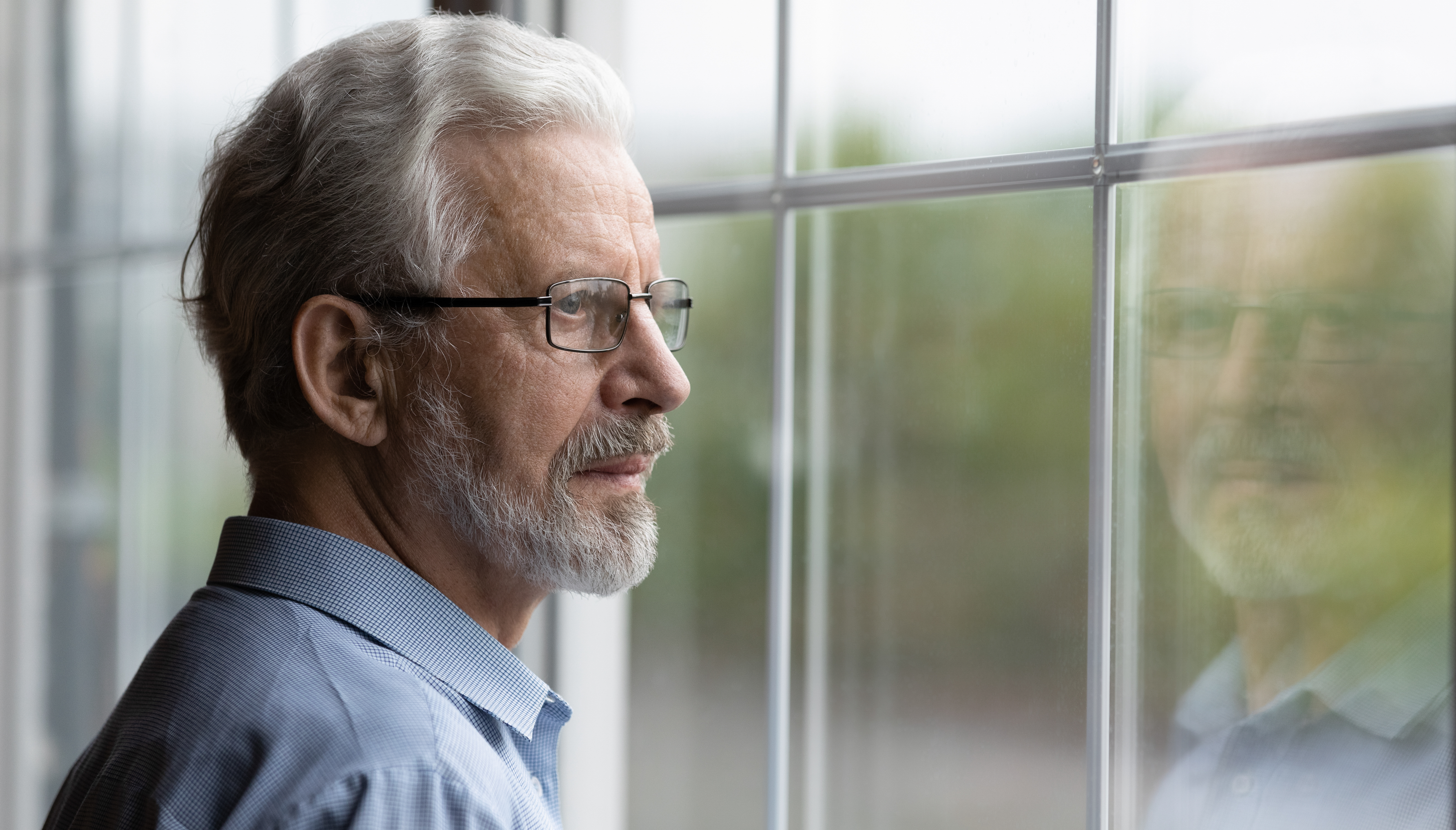 Man looking out miami window